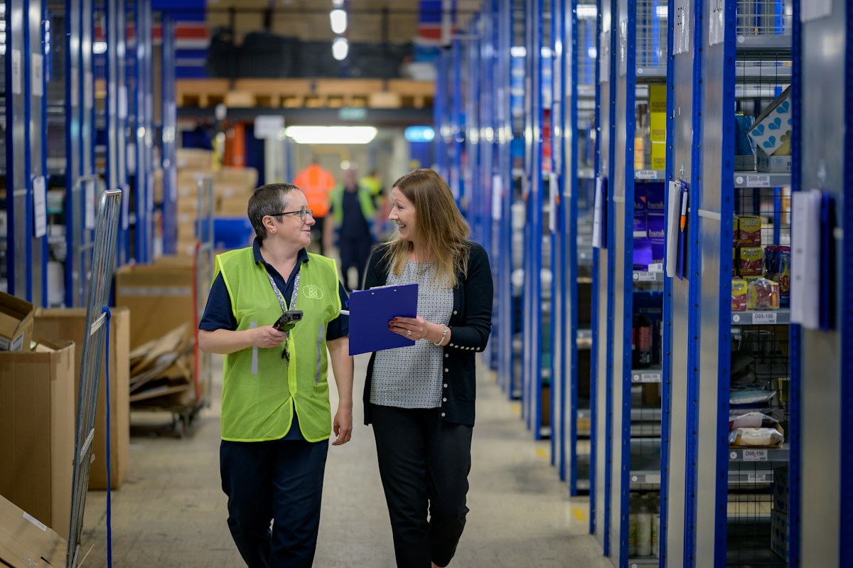 Warehouse worker beside a delivery vehicle